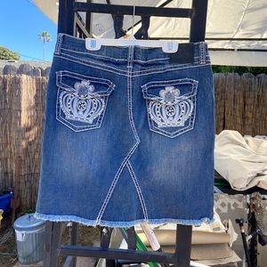 This denim skirt with the crowns in the back is giving very Y2K vibes.